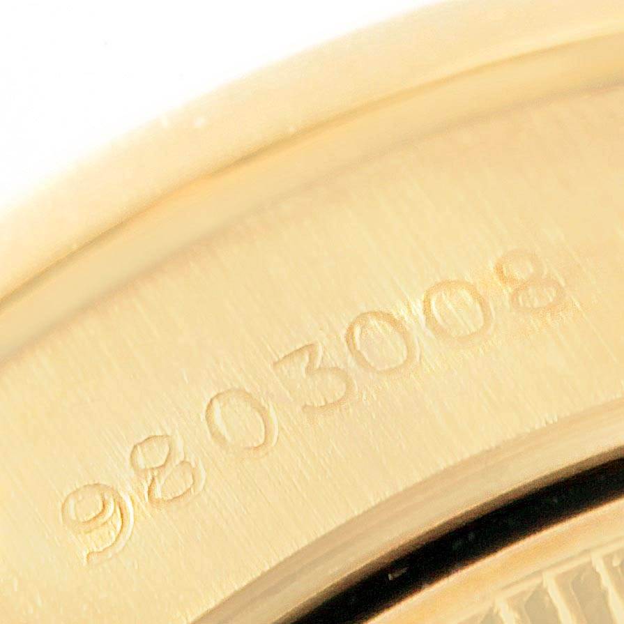 This close-up image shows the serial number engraved on the back case of a Rolex President 69138 Women's Yellow Gold Silver Dial 69138 Women's Yellow Gold Silver Dial model watch.