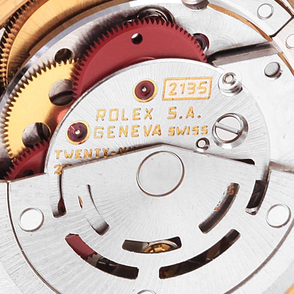 The image shows a close-up view of the movement mechanism of a Rolex President 69138 Women's Yellow Gold Silver Dial 69138 Women's Yellow Gold Silver Dial watch, highlighting gears and Rolex engraving.