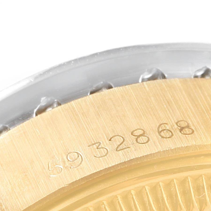 This close-up image shows the edge of the bezel on a Rolex President 6917 Women
s Yellow Gold Champagne Dial 6917 Women
s Yellow Gold Champagne Dial watch, highlighting its serial number engraving.