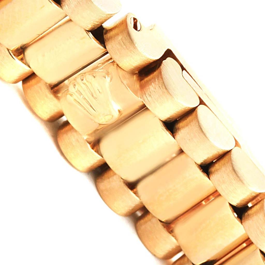 This close-up image shows the gold link bracelet of a Rolex President 6917 Women
s Yellow Gold Champagne Dial 6917 Women
s Yellow Gold Champagne Dial model watch, featuring the Rolex crown logo.