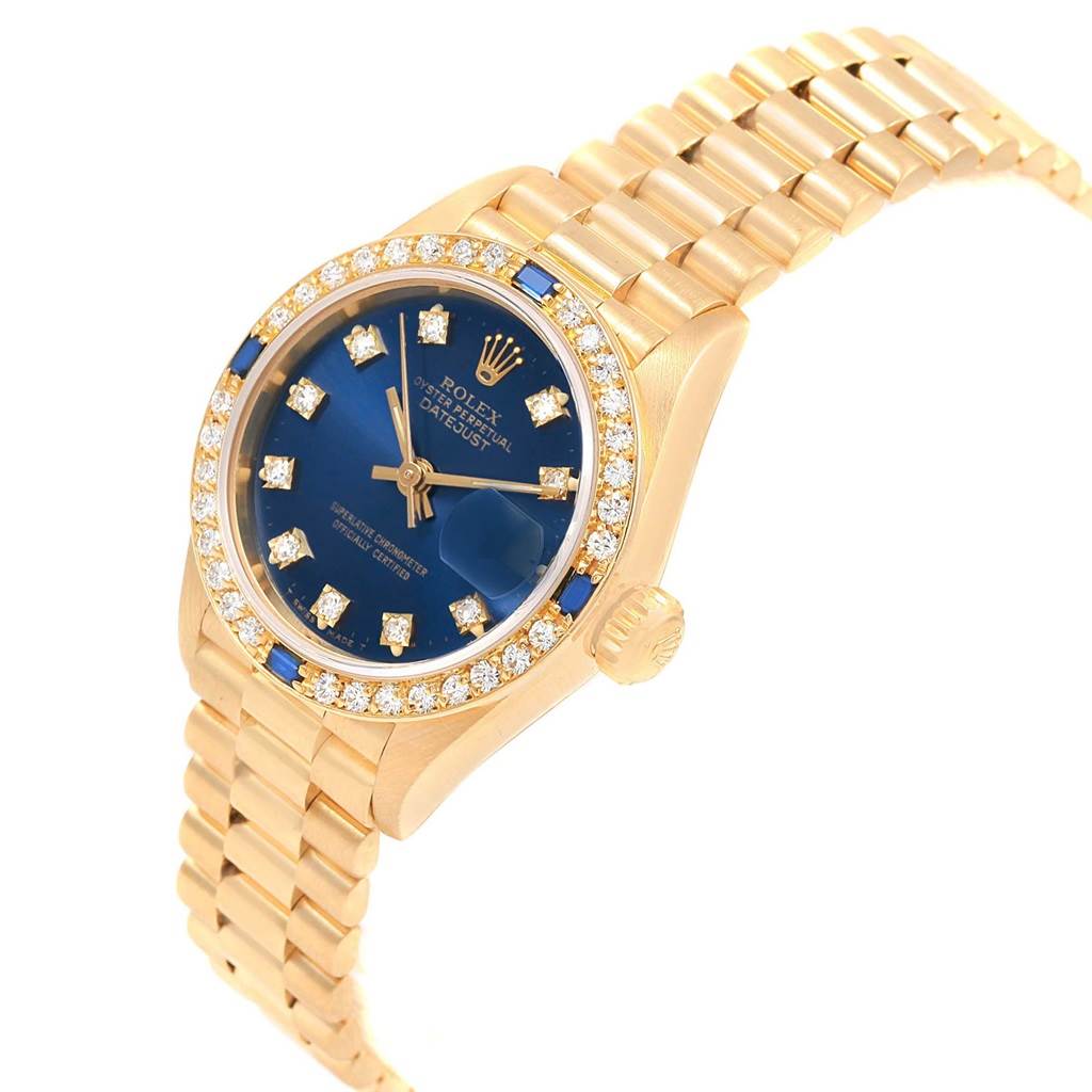 This image shows a Rolex President 69178 Women's Yellow Gold Blue Dial 69178 Women's Yellow Gold Blue Dial model watch at an angled view, highlighting the dial, bezel, crown, and part of the bracelet.