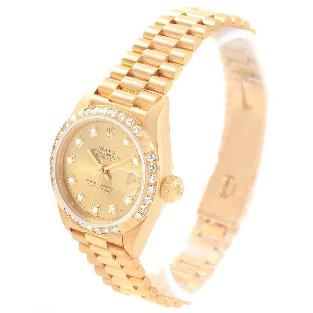 The image shows a Rolex President 79268 Women
s Yellow Gold Champagne Dial 79268 Women
s Yellow Gold Champagne Dial model watch at a slight angle, displaying its gold bracelet, watch face, and diamond bezel.