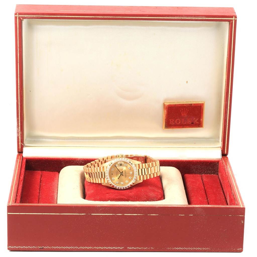 The Rolex President 79268 Women
s Yellow Gold Champagne Dial 79268 Women
s Yellow Gold Champagne Dial model watch is displayed front-facing inside an open red box with a cushion.