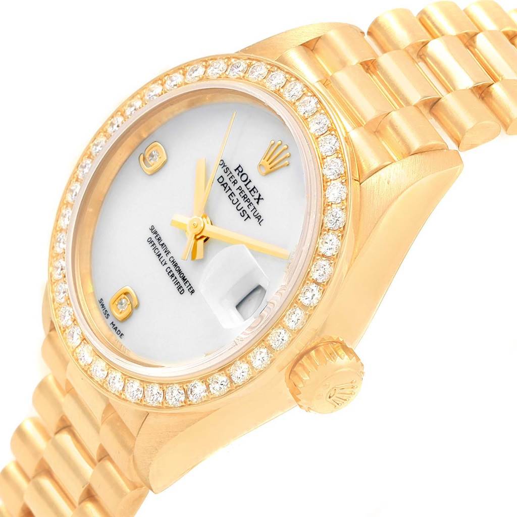 The image shows a close-up angled view of a Rolex President 79138 Women
s Yellow Gold White Dial 79138 Women
s Yellow Gold White Dial model watch, highlighting its diamond bezel, dial, and bracelet.