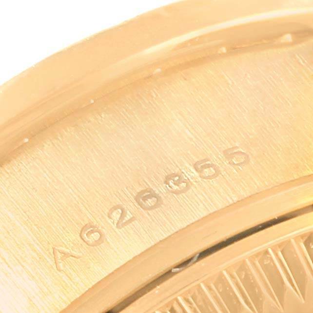 The image shows a close-up angle of the serial number inscribed on the gold case of a Rolex President 79138 Women
s Yellow Gold White Dial 79138 Women
s Yellow Gold White Dial model watch.