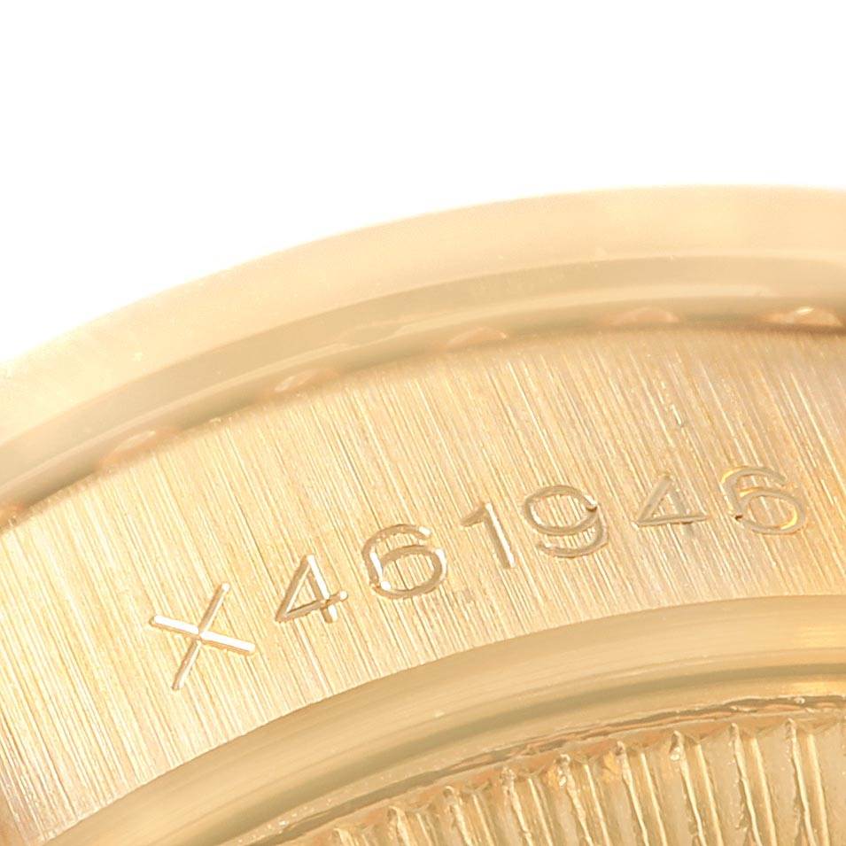 This close-up image shows the serial number engraving on the gold casing of a Rolex President 69158 Women
s Yellow Gold Champagne Dial 69158 Women
s Yellow Gold Champagne Dial model watch.