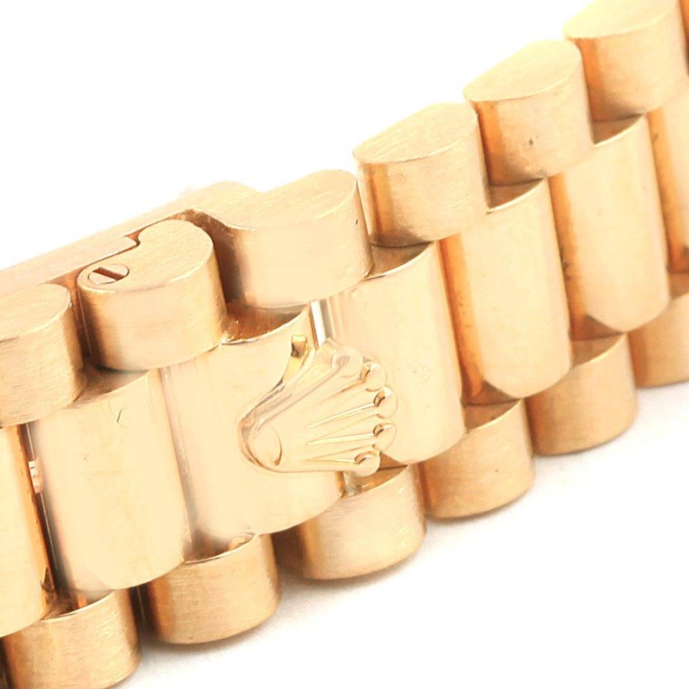 This image shows a close-up of the bracelet of a Rolex President 69158 Women
s Yellow Gold Champagne Dial 69158 Women
s Yellow Gold Champagne Dial model watch, highlighting the gold links and the Rolex crown logo.