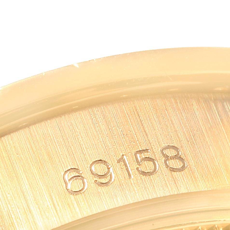 The image shows a close-up of the inner case back of a Rolex President 69158 Women
s Yellow Gold Champagne Dial 69158 Women
s Yellow Gold Champagne Dial model watch, highlighting its serial number.