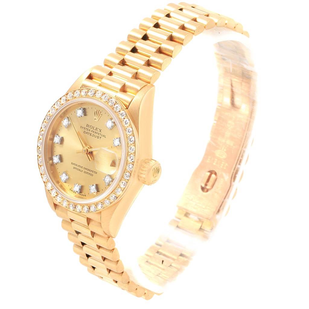 The Rolex President 69138 Women
s Yellow Gold Champagne Dial 69138 Women
s Yellow Gold Champagne Dial model watch is shown at a slight angle, displaying its gold bracelet, bezel with diamonds, and dial.