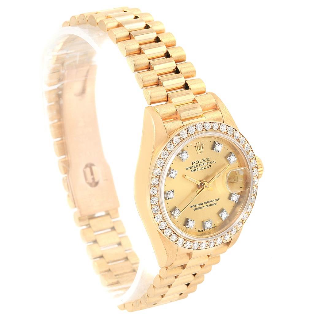 The image shows a gold Rolex President 69138 Women
s Yellow Gold Champagne Dial 69138 Women
s Yellow Gold Champagne Dial model watch with a diamond bezel and bracelet, angled to the right.