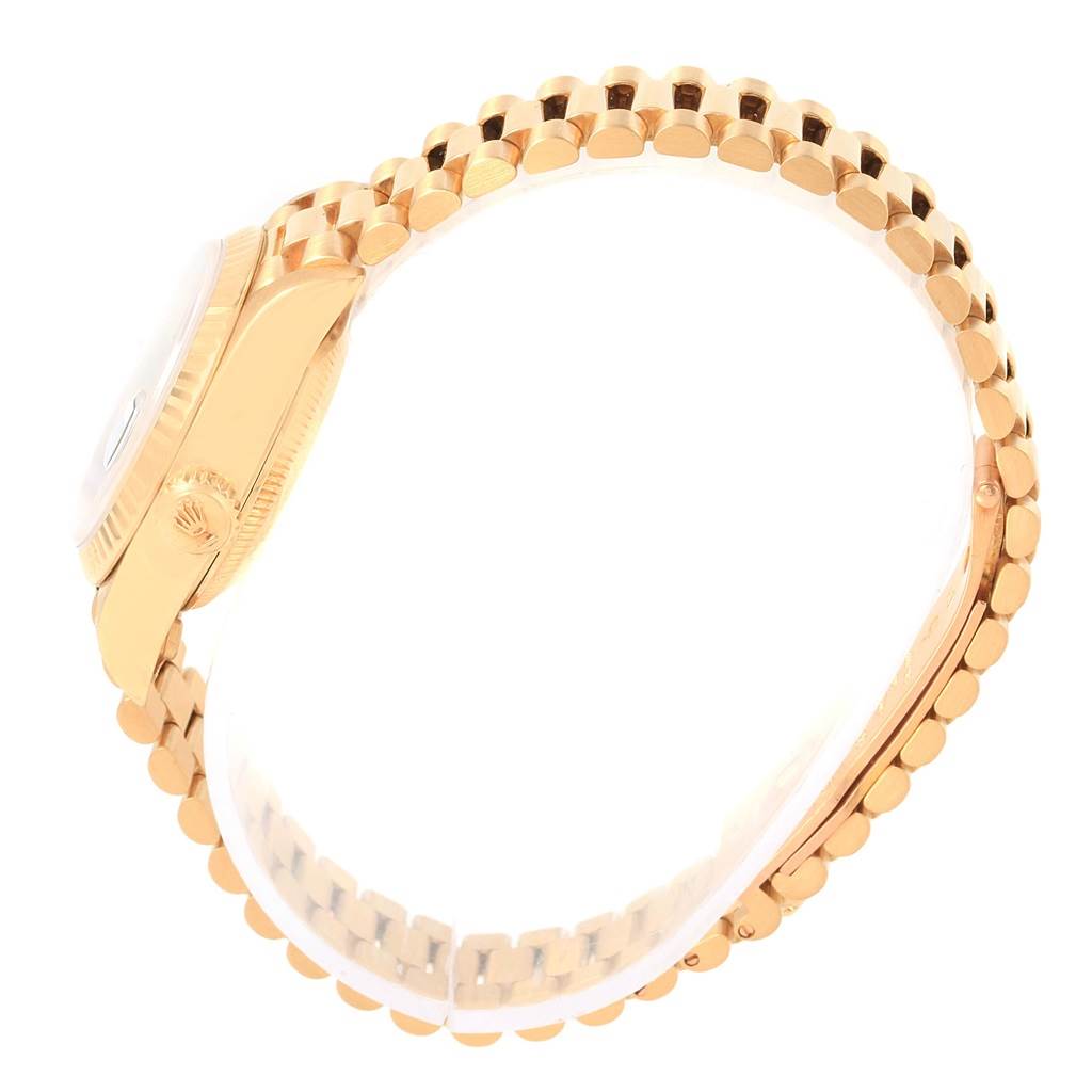 This side view of the Rolex President 69178 Women's Yellow Gold Blue Dial 69178 Women's Yellow Gold Blue Dial model watch highlights the case, crown, and bracelet.