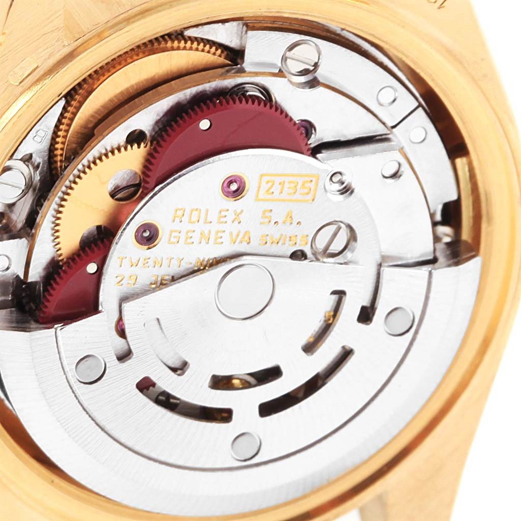 This image shows a close-up view of the interior mechanics of a Rolex President 69178 Women's Yellow Gold Blue Dial 69178 Women's Yellow Gold Blue Dial model watch, highlighting its gears and rotor.