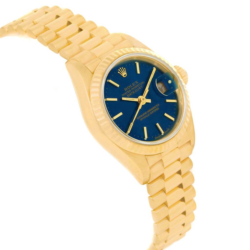 The Rolex President 69178 Women's Yellow Gold Blue Dial 69178 Women's Yellow Gold Blue Dial watch model is shown at an angled side view, highlighting its gold case, blue dial, date window, and gold bracelet.