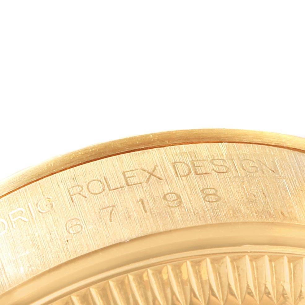 The image shows a close-up angle of the engraved side of the Rolex President 67198 Women
s Yellow Gold Champagne Dial 67198 Women
s Yellow Gold Champagne Dial model watch case.