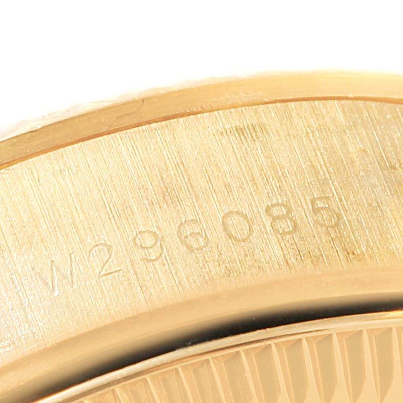 This close-up image of a Rolex President 67198 Women
s Yellow Gold Champagne Dial 67198 Women
s Yellow Gold Champagne Dial model watch shows the engraved serial numbers on its gold case.