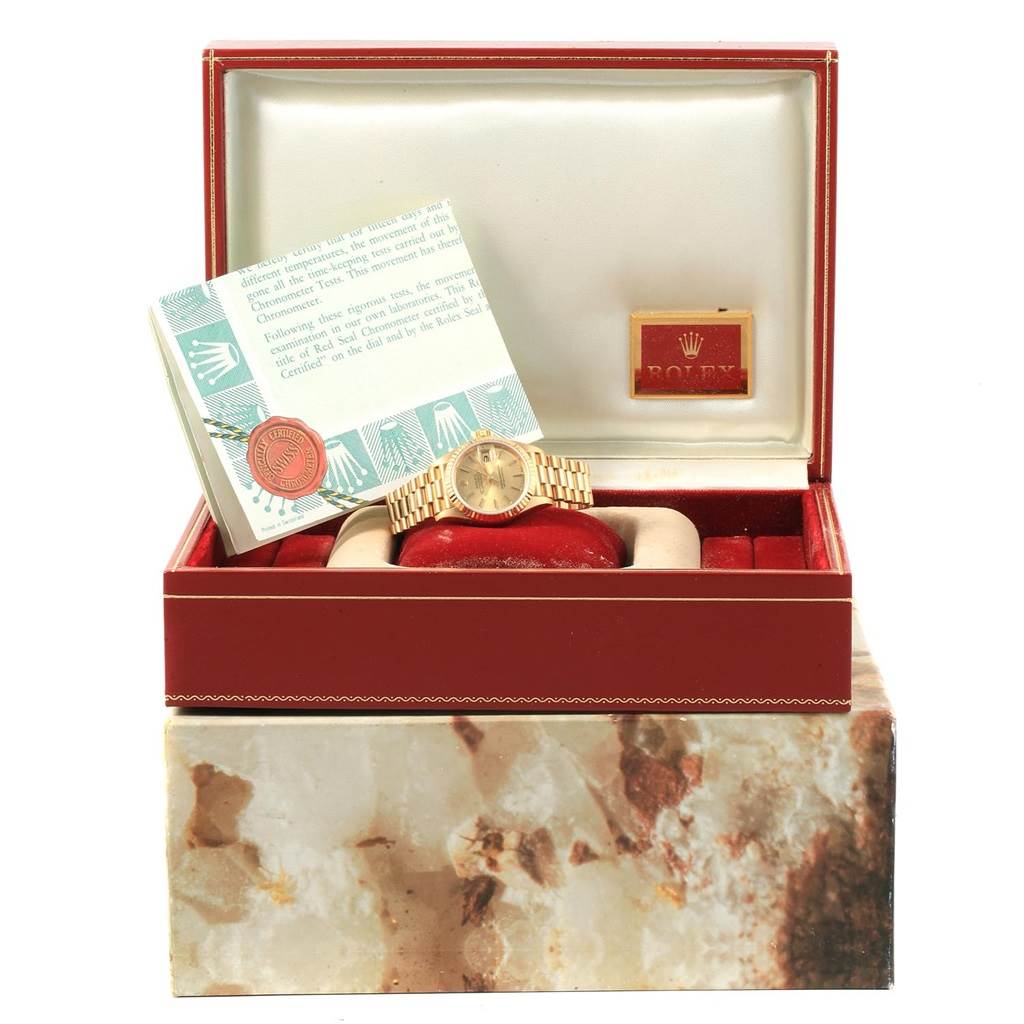 The image shows a Rolex President 69178 Women
s Yellow Gold Champagne Dial 69178 Women
s Yellow Gold Champagne Dial model watch in its box, along with documentation, from a frontal angle.