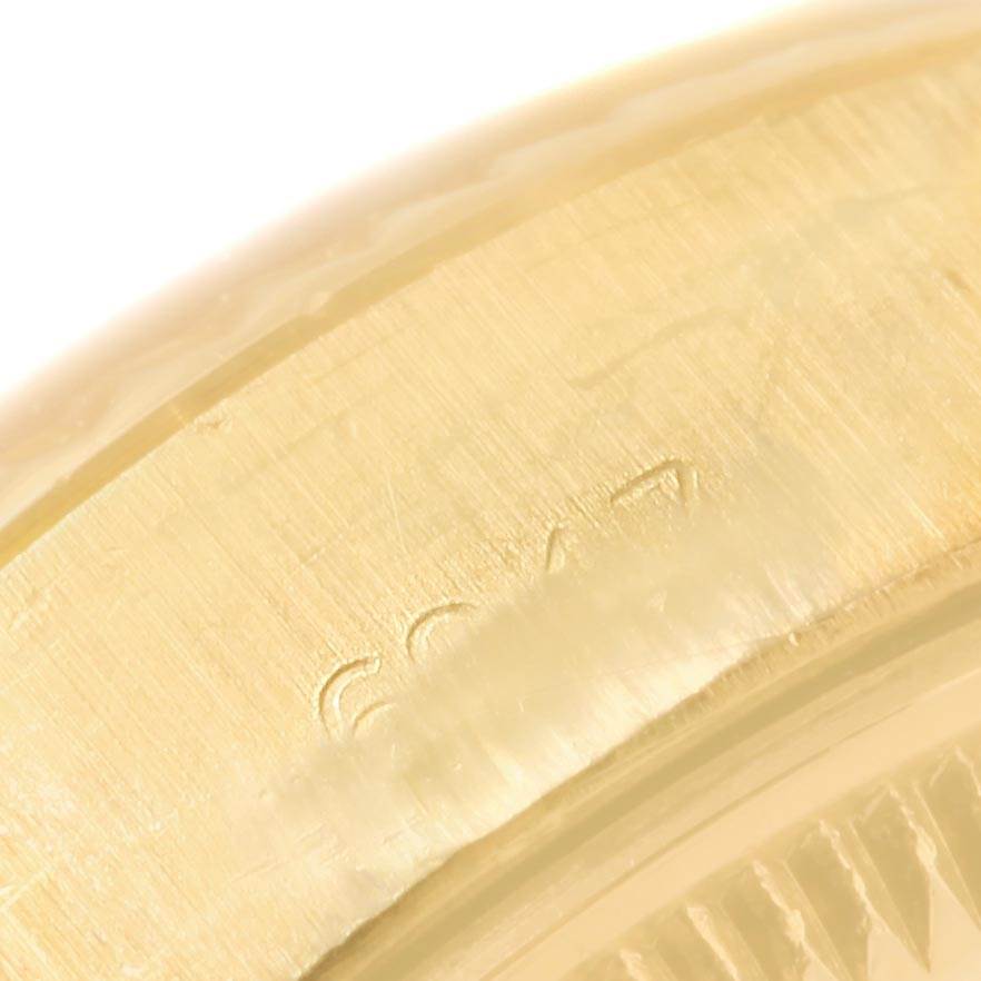 This is a close-up view of the edge of a Rolex President 6917 Women's Yellow Gold Brown Dial 6917 Women's Yellow Gold Brown Dial model, showing the serial number engraving.