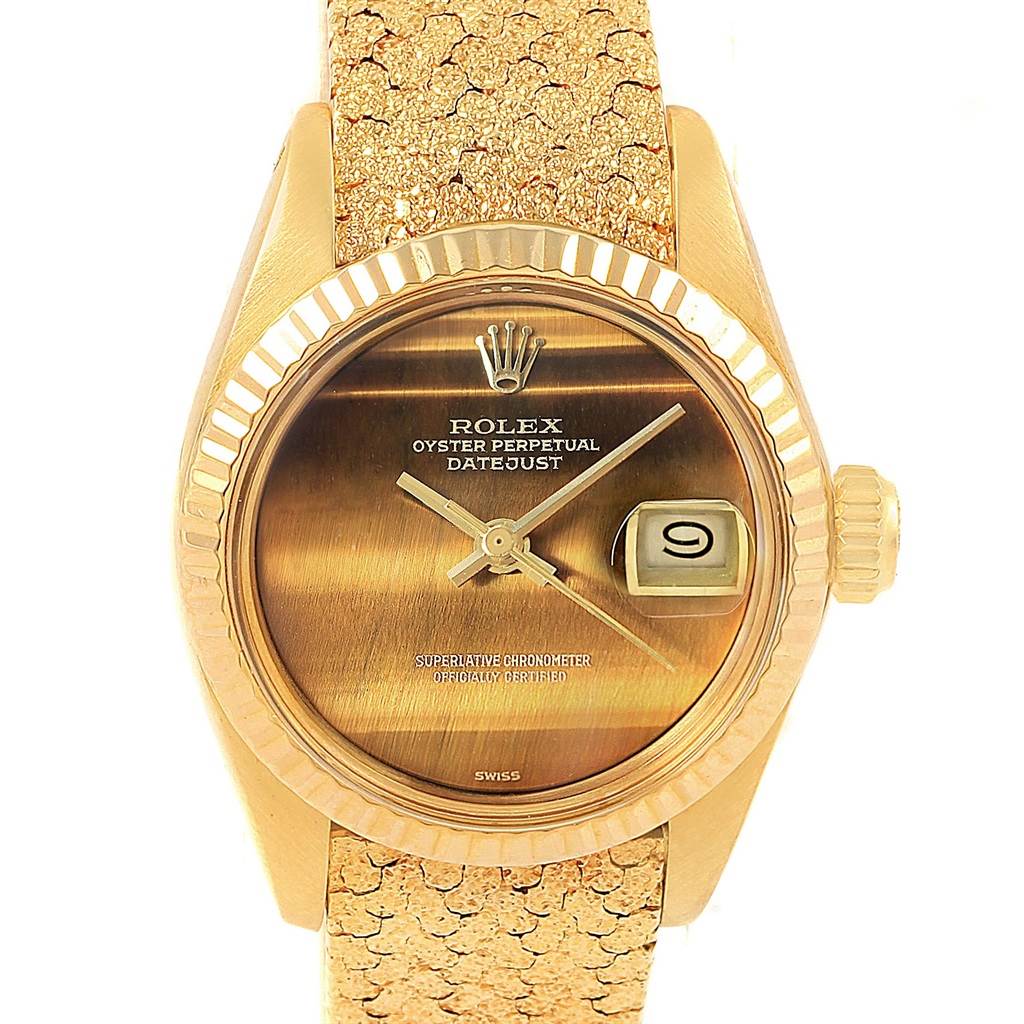 This is a front view of a Rolex President 6917 Women's Yellow Gold Brown Dial 6917 Women's Yellow Gold Brown Dial model watch, showcasing the dial, crown, and part of the textured strap.