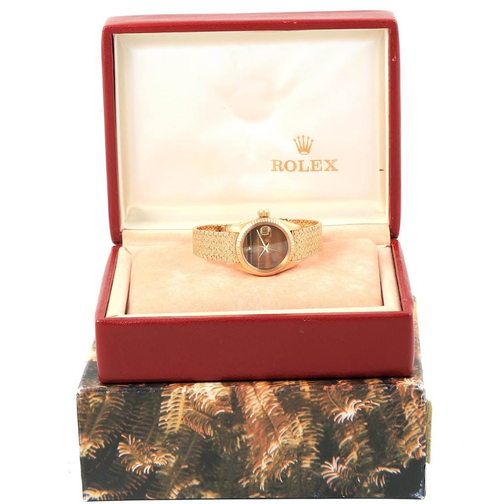 The Rolex President 6917 Women's Yellow Gold Brown Dial 6917 Women's Yellow Gold Brown Dial model watch is shown at a front angle inside its open branded case.