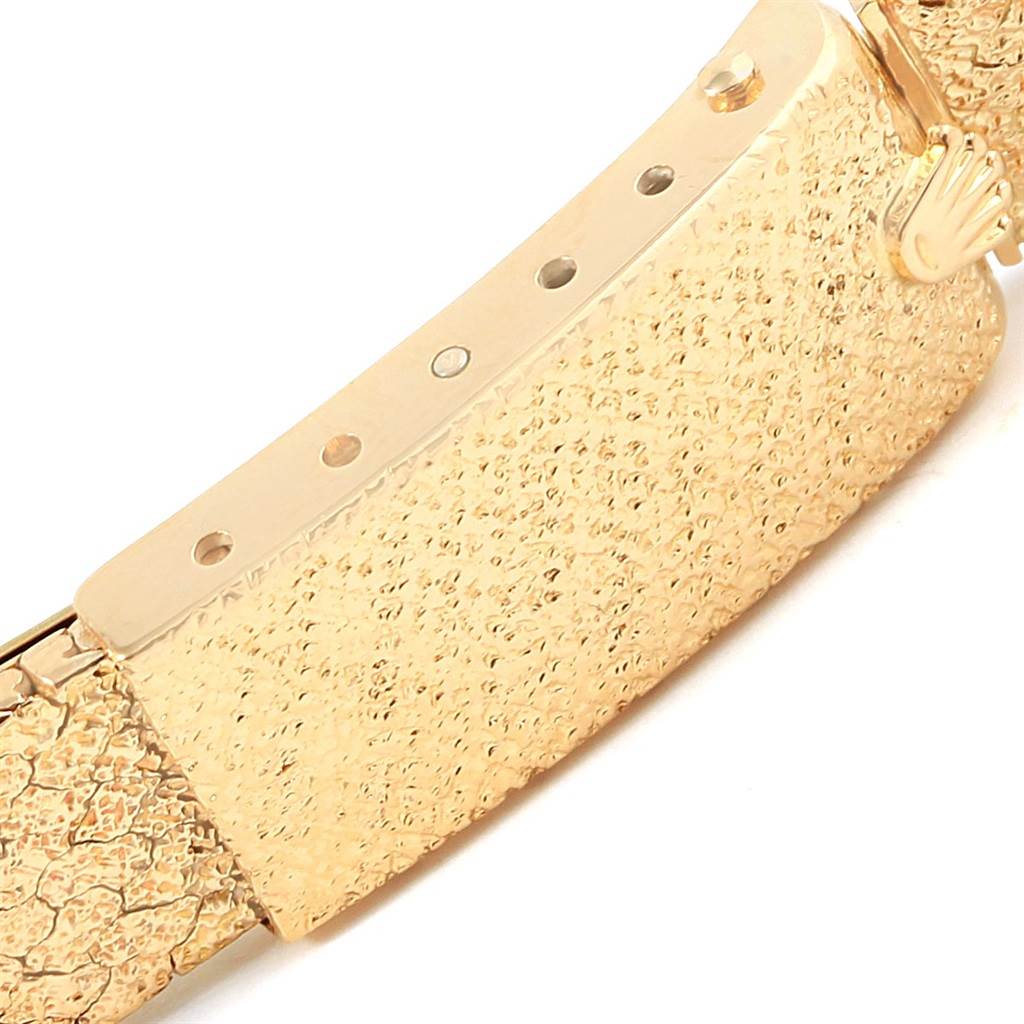 The image shows a close-up of the textured clasp and bracelet of a Rolex President 6917 Women's Yellow Gold Brown Dial 6917 Women's Yellow Gold Brown Dial model watch.