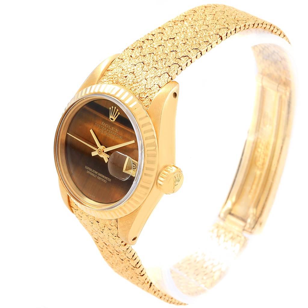 The Rolex President 6917 Women's Yellow Gold Brown Dial 6917 Women's Yellow Gold Brown Dial model watch is shown at a slight angled view, displaying its face, crown, and textured band.