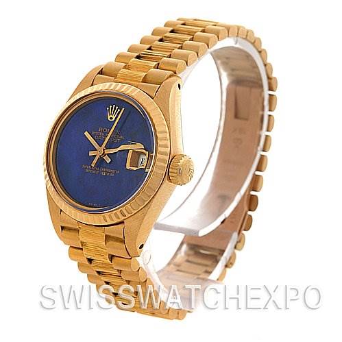 The image shows a Rolex President 6917 Women's Yellow Gold Blue Dial 6917 Women's Yellow Gold Blue Dial model watch angled to display the face, crown, and part of the bracelet.