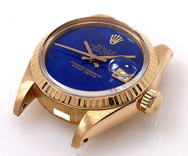 The image shows a Rolex President 6917 Women's Yellow Gold Blue Dial 6917 Women's Yellow Gold Blue Dial model watch from an oblique angle, highlighting its blue dial, gold case, crown, and lugs.