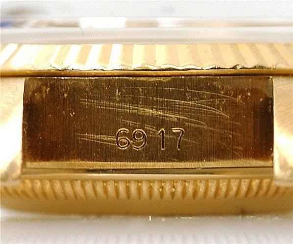 The image shows a close-up of the engraved model number "6917" on a Rolex President 6917 Women's Yellow Gold Blue Dial 6917 Women's Yellow Gold Blue Dial watch's gold case side.