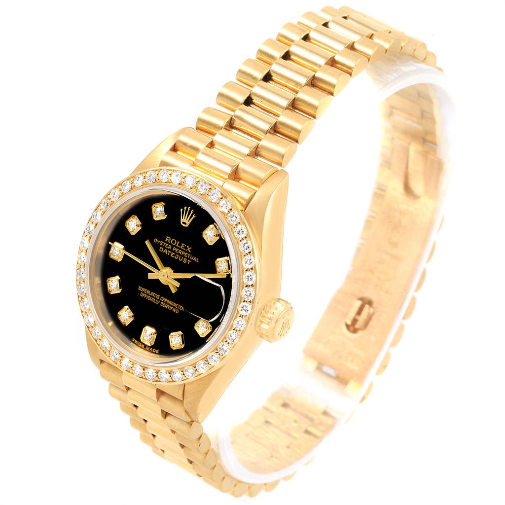 This image shows a Rolex President 69138 Women
s Yellow Gold Black Dial 69138 Women
s Yellow Gold Black Dial model watch from an angled view, showcasing the black dial, diamond bezel, and gold bracelet.
