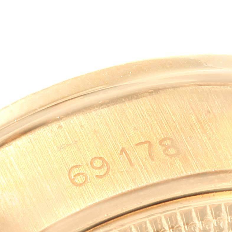 This close-up image shows part of the case back with the model number "69178" engraved on a Rolex President 69178 Women's Yellow Gold Orange Dial 69178 Women's Yellow Gold Orange Dial watch.
