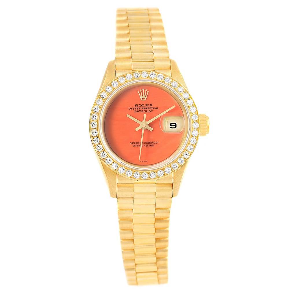 This image shows a Rolex President 69178 Women's Yellow Gold Orange Dial 69178 Women's Yellow Gold Orange Dial Datejust watch from a top-down angle, highlighting the dial, bracelet, bezel, and date window.