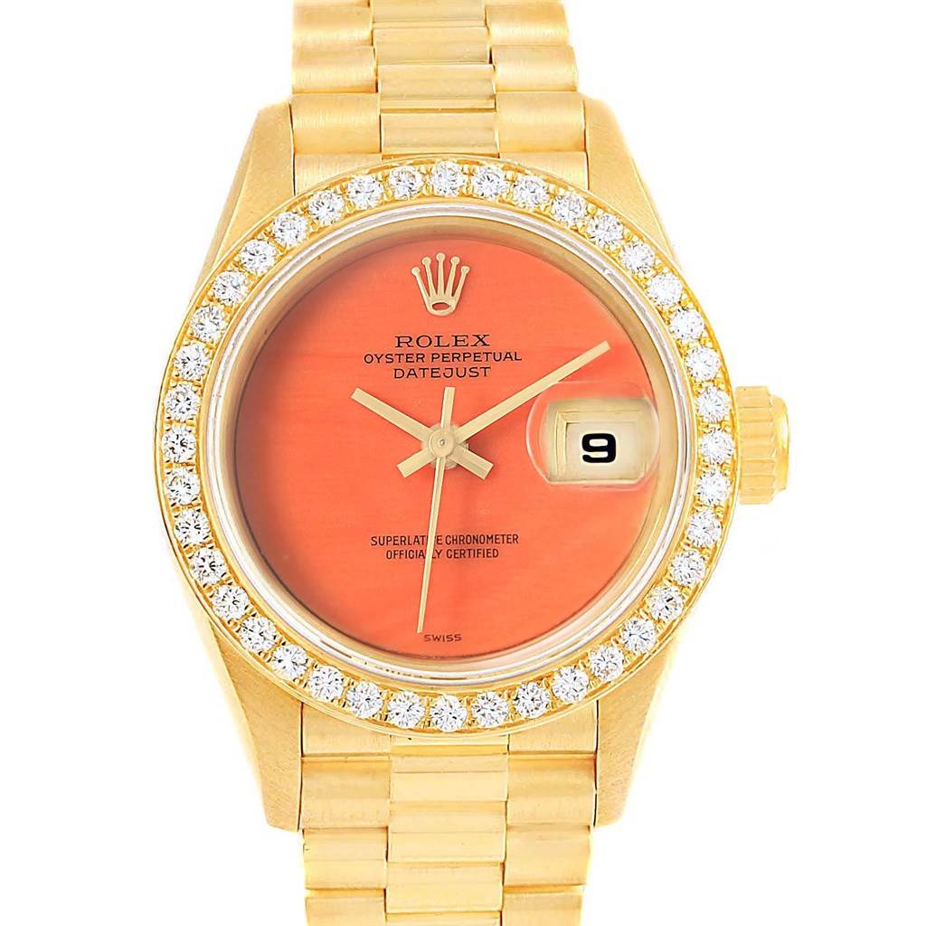This image shows a frontal view of the Rolex President 69178 Women's Yellow Gold Orange Dial 69178 Women's Yellow Gold Orange Dial Datejust watch, highlighting its orange dial, diamond bezel, and gold bracelet.