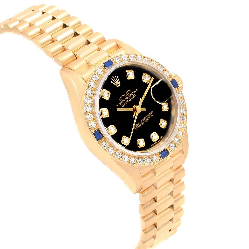 The image shows a side and front angle of the Rolex President 79088 Women's Yellow Gold Black Dial 79088 Women's Yellow Gold Black Dial model watch, highlighting its black dial, golden bracelet, and diamond bezel.