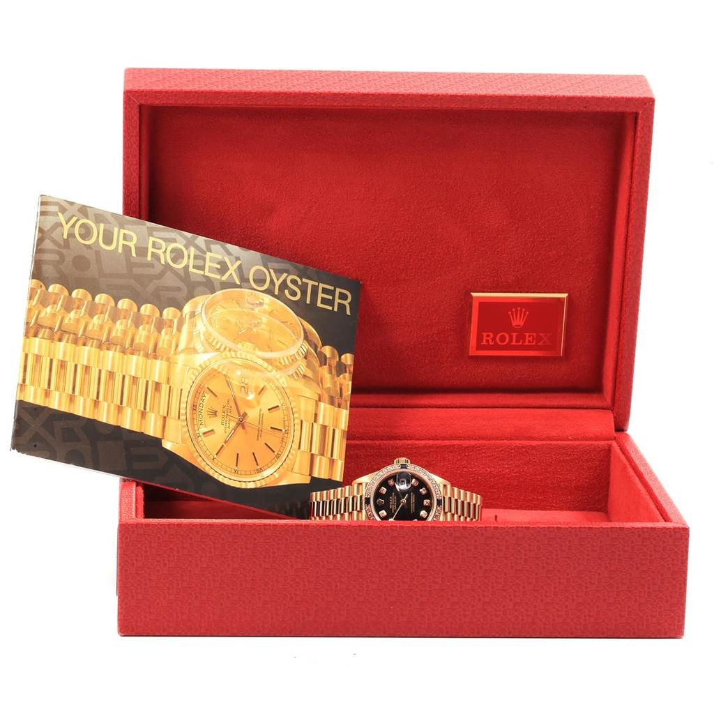 The image shows a Rolex President 79088 Women's Yellow Gold Black Dial 79088 Women's Yellow Gold Black Dial model watch in a red box with a Rolex brochure beside it.