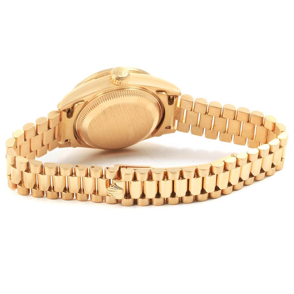 The image shows the back and band of the Rolex President 79088 Women's Yellow Gold Black Dial 79088 Women's Yellow Gold Black Dial watch, showcasing the gold case and bracelet.