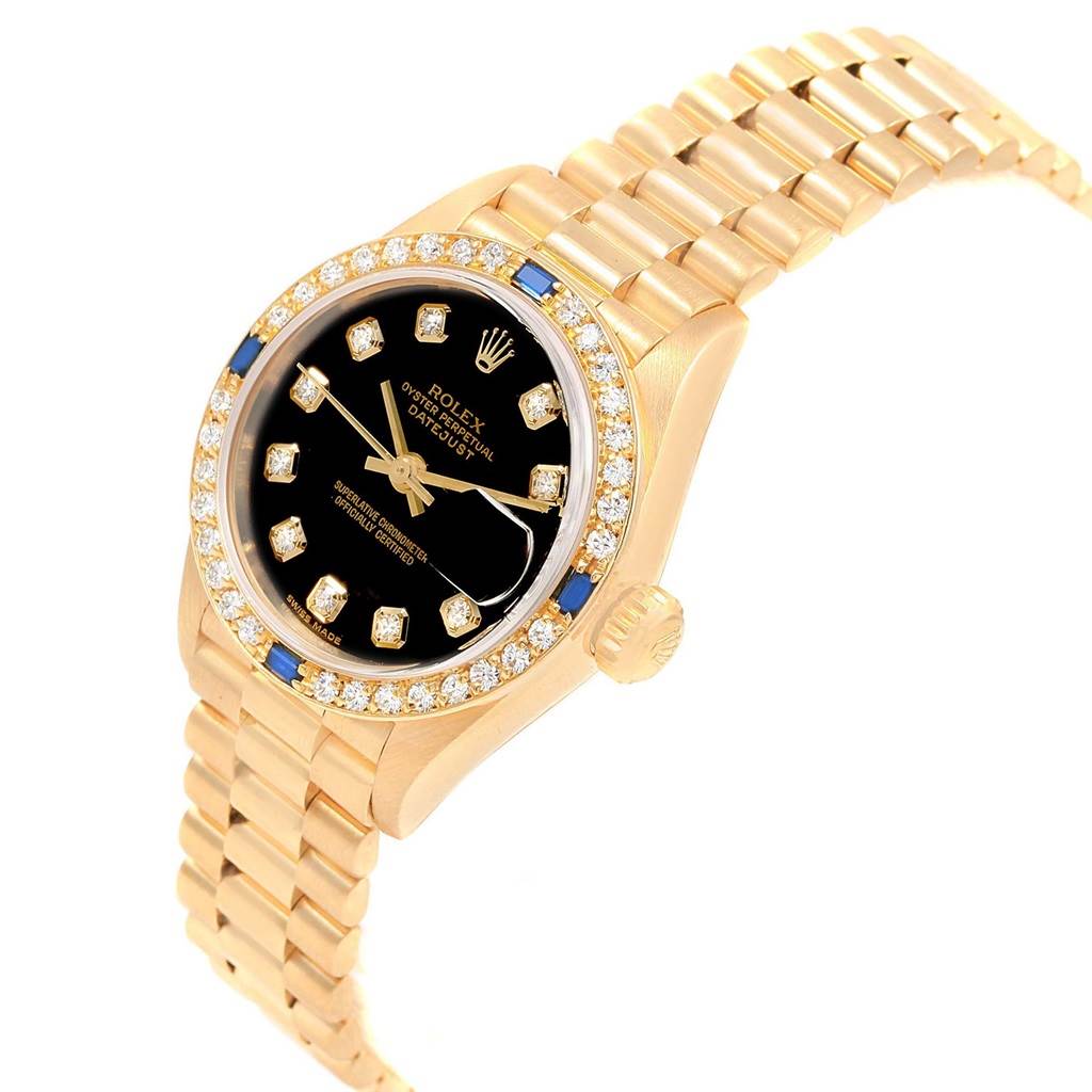 The Rolex President 79088 Women's Yellow Gold Black Dial 79088 Women's Yellow Gold Black Dial model watch is shown at an angled view highlighting its gold bracelet, black dial, and diamond-set bezel.