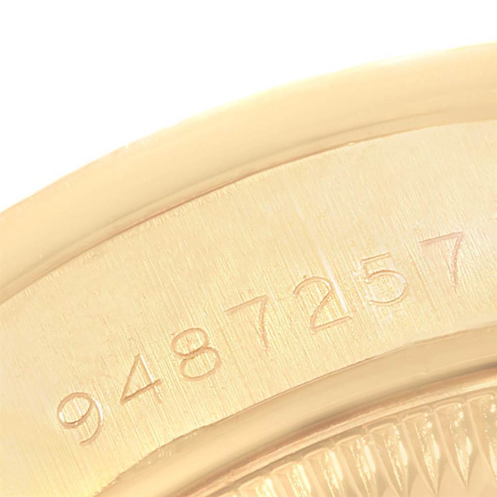 This close-up image shows part of the serial number engraving on the case of a Rolex President 69038 Women
s Yellow Gold Champagne Dial 69038 Women
s Yellow Gold Champagne Dial model watch.