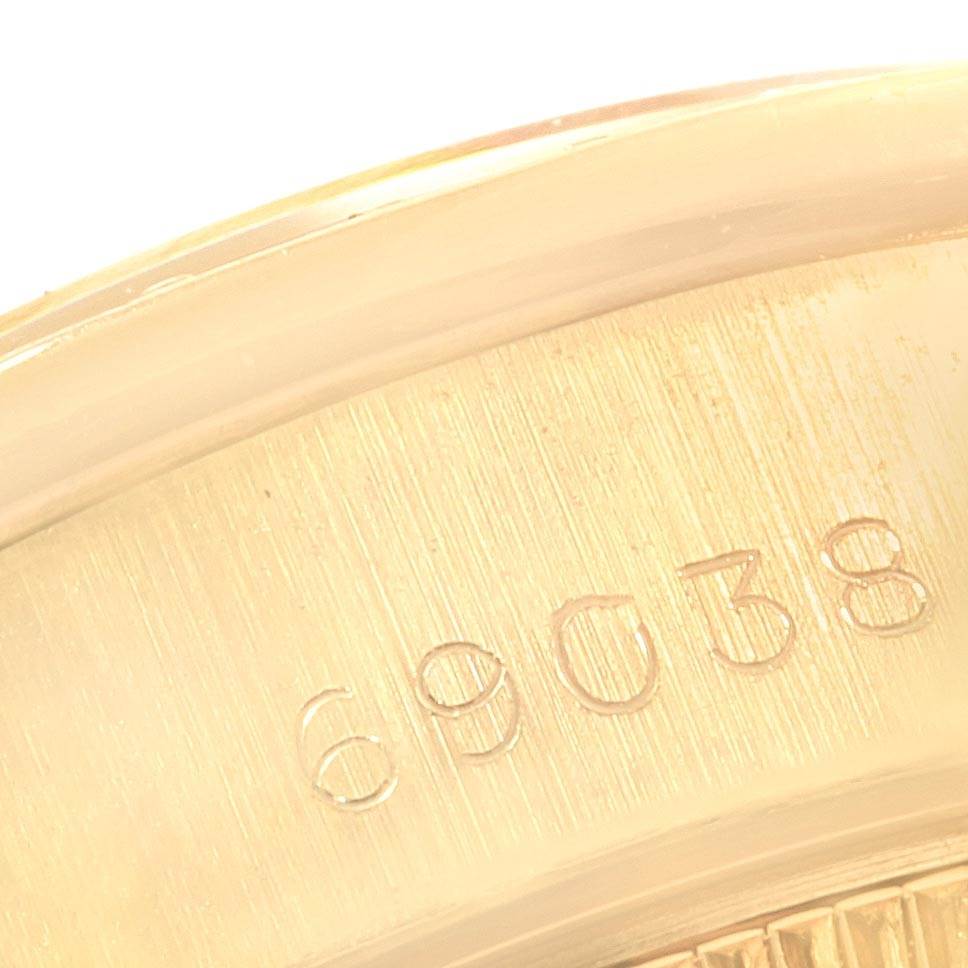 This image shows a close-up of the case back and serial number of a Rolex President 69038 Women
s Yellow Gold Champagne Dial 69038 Women
s Yellow Gold Champagne Dial model watch.