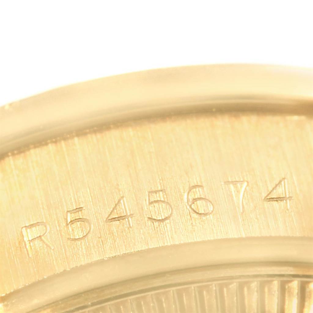 This image shows a close-up of the serial number on the case back of a Rolex President 69158 Women
s Yellow Gold Silver Dial 69158 Women
s Yellow Gold Silver Dial model watch.