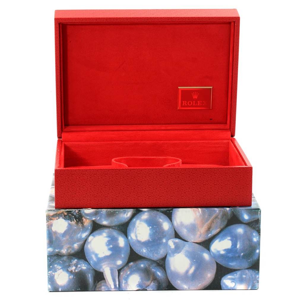 This image shows an open Rolex President 69158 Women
s Yellow Gold Silver Dial 69158 Women
s Yellow Gold Silver Dial model watch box, with red interior and a pearl-patterned exterior.