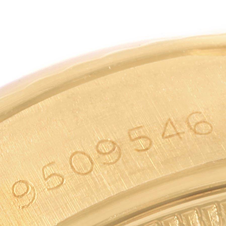 This close-up angle of the Rolex President 69178 Women's Yellow Gold Black Dial 69178 Women's Yellow Gold Black Dial model shows a partial view of the gold casing with a visible serial number.