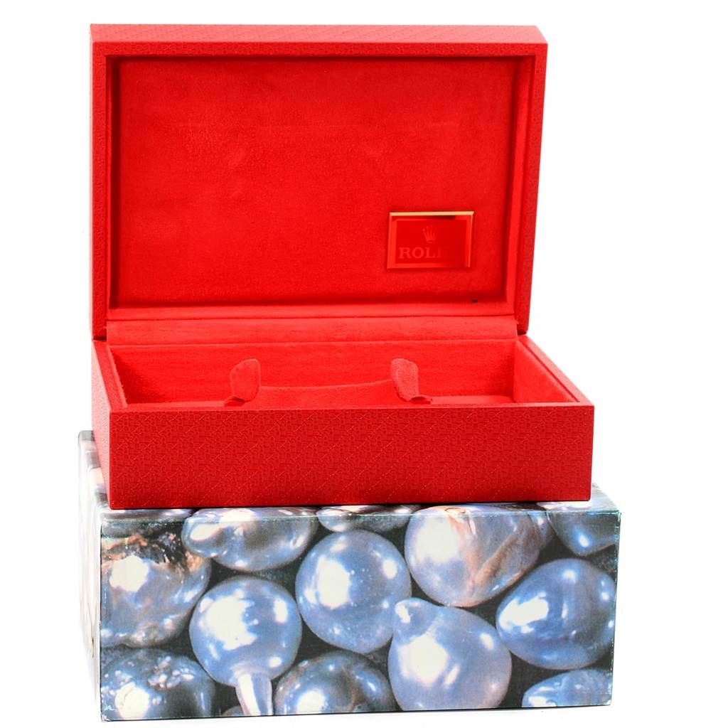 This image shows the open box for a Rolex President 69178 Women's Yellow Gold Black Dial 69178 Women's Yellow Gold Black Dial model watch, with its inner red compartment and outer decorative packaging.