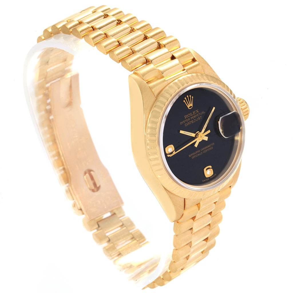 The image shows a Rolex President 69178 Women's Yellow Gold Black Dial 69178 Women's Yellow Gold Black Dial model watch at a slight angle, highlighting the gold band, black dial, and the distinctive date magnifier.