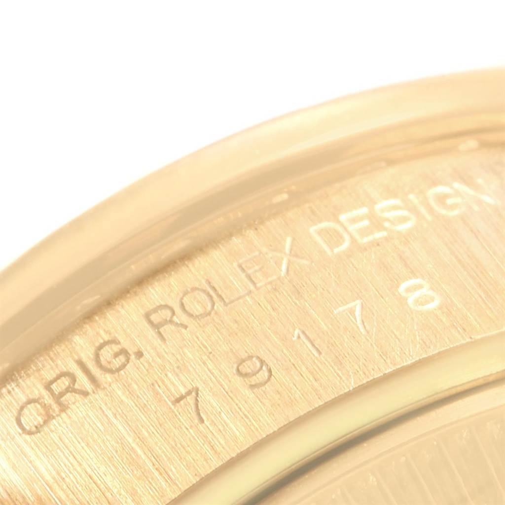 The image shows a close-up of the engraved text on the case back rim of a Rolex President 79178 Women
s Yellow Gold Champagne Dial 79178 Women
s Yellow Gold Champagne Dial model watch.