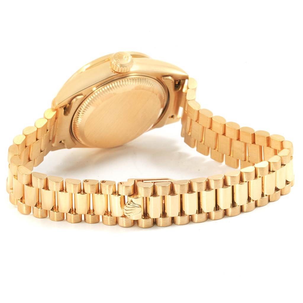 The image shows the back of a gold Rolex President 79178 Women
s Yellow Gold Champagne Dial 79178 Women
s Yellow Gold Champagne Dial model watch, highlighting the case back and part of the bracelet.