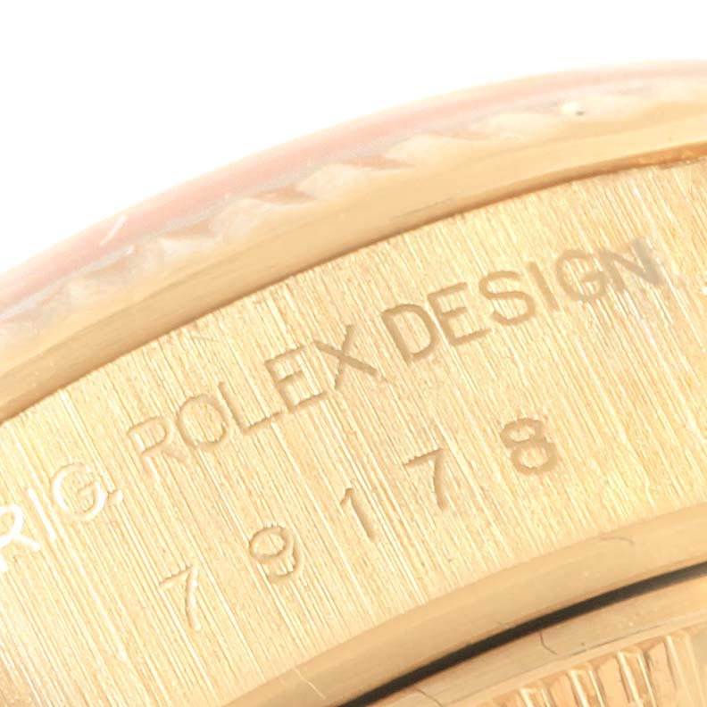 This close-up image shows the engraved serial number and "Rolex Design" on the side of the bezel of the Rolex President 79178 Women
s Yellow Gold Champagne Dial 79178 Women
s Yellow Gold Champagne Dial watch.