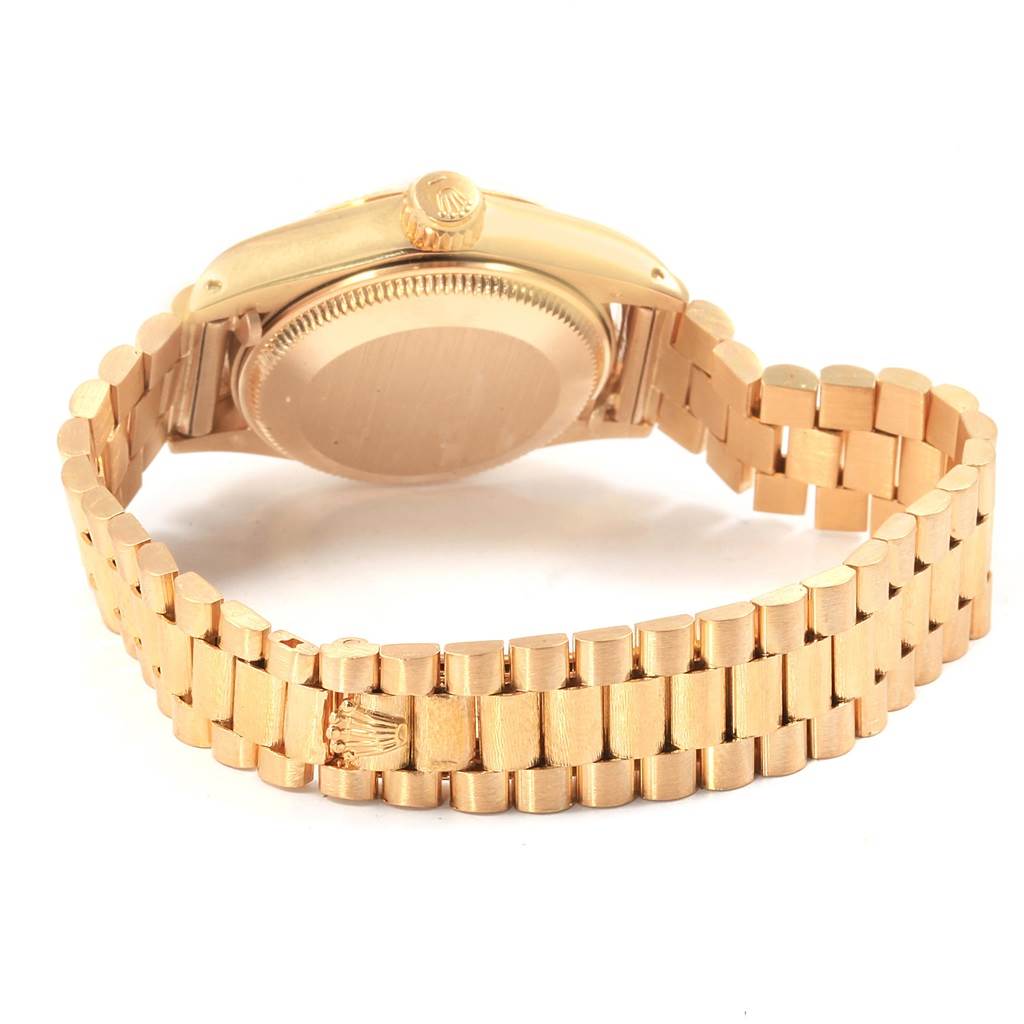 The image shows the back and side view of the Rolex President 6917 Women's Yellow Gold Champagne Dial 6917 Women's Yellow Gold Champagne Dial model watch, highlighting its links, clasp, and crown.