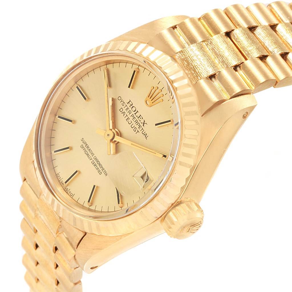 The image shows a gold Rolex President 6917 Women's Yellow Gold Champagne Dial 6917 Women's Yellow Gold Champagne Dial model watch from an angled side view, highlighting its dial, crown, and bracelet.