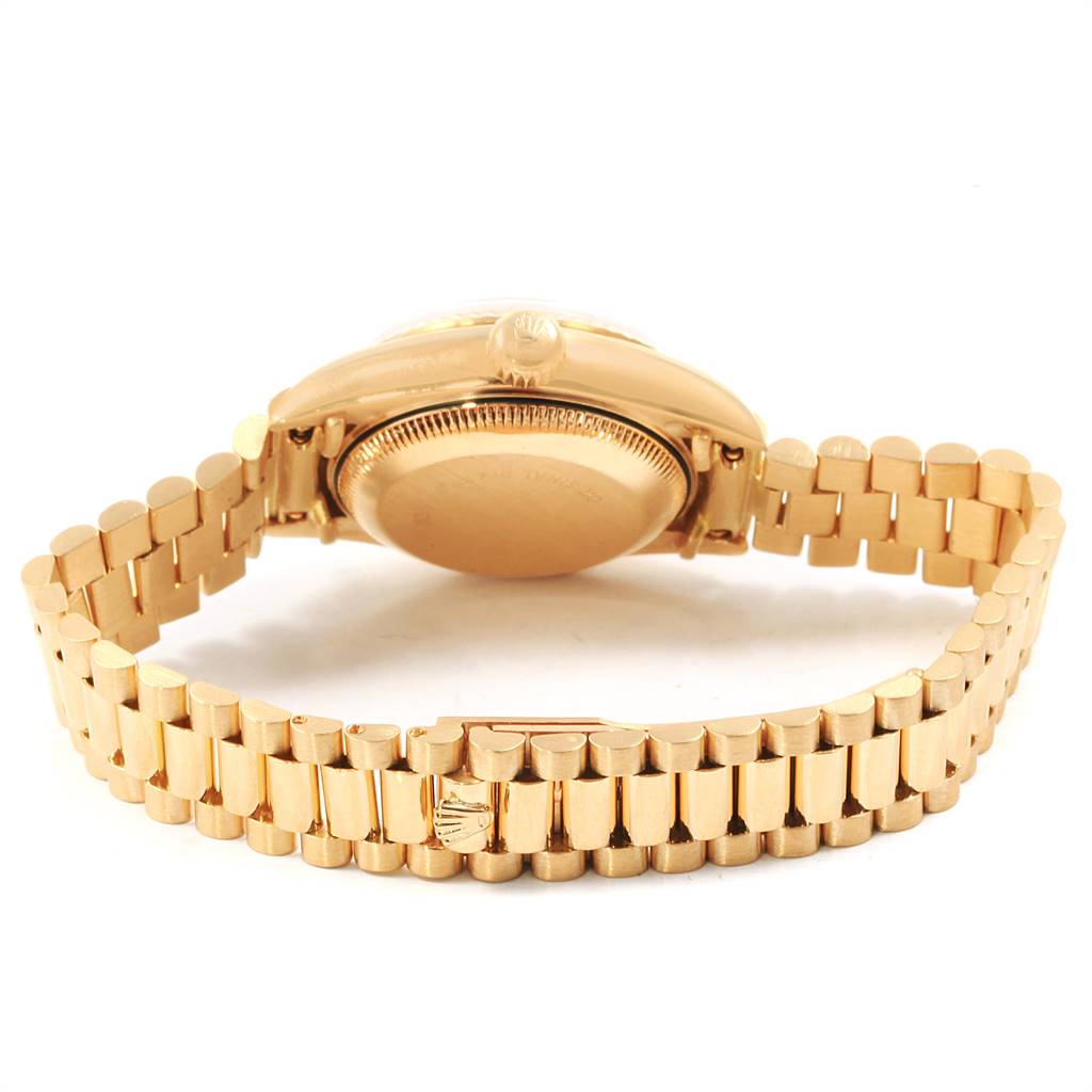 This image shows the back and bracelet of a Rolex President 69178 Women's Yellow Gold Beige Dial 69178 Women's Yellow Gold Beige Dial model watch from a low-angle perspective.