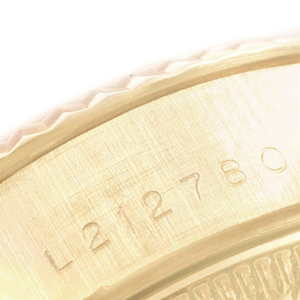 This close-up image shows a portion of the caseback with the serial number of a Rolex President 69178 Women's Yellow Gold Beige Dial 69178 Women's Yellow Gold Beige Dial model watch.